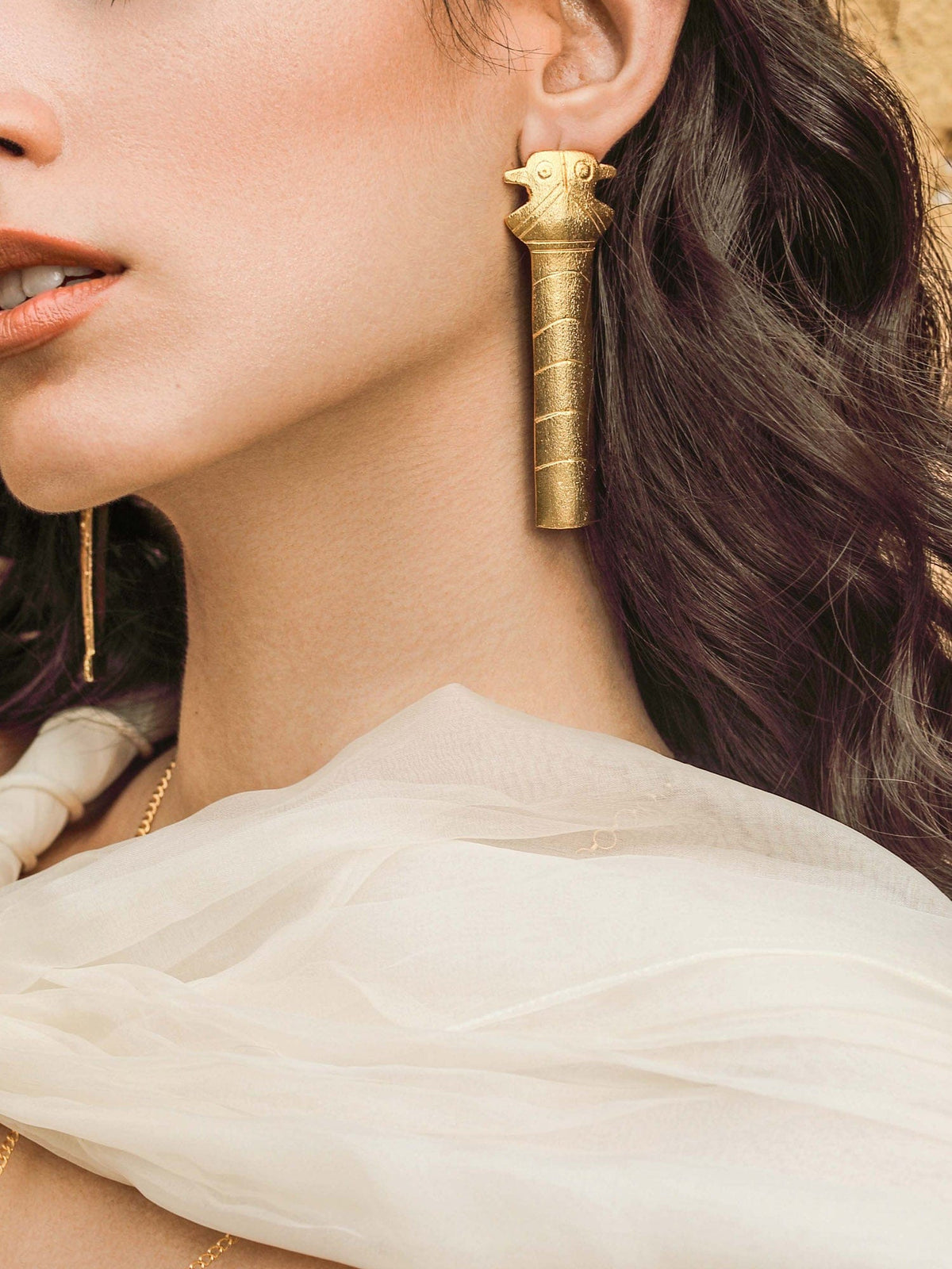 Statuesque mismatched earrings